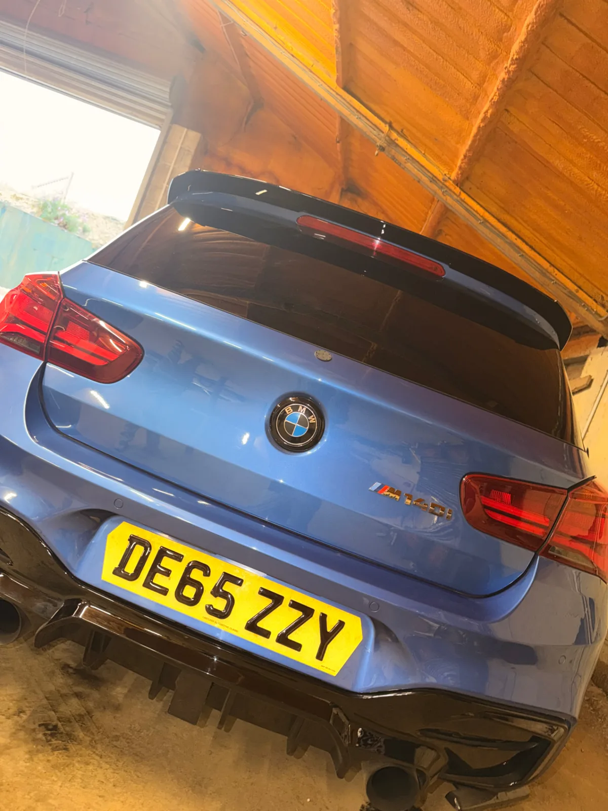 Blue BMW M140i fitted with a yellow 4D gel number plate